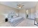 Spacious main bedroom features plush carpet, neutral paint, ceiling fan, and ensuite bath at 31101 Black Eagle Dr # 202, Evergreen, CO 80439
