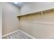 Clean walk-in closet featuring carpeted floors, neutral paint, and a mounted clothing rod at 31101 Black Eagle Dr # 202, Evergreen, CO 80439