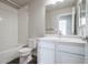 Bathroom with white tiled shower and vanity and neutral walls at 16069 E Elk Dr, Denver, CO 80239