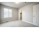 Carpeted bedroom with window providing natural light and walk-in closet at 16069 E Elk Dr, Denver, CO 80239