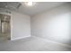 Bright, carpeted room with white trim and access to the hall at 16069 E Elk Dr, Denver, CO 80239