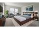 Bedroom featuring a large bed, two windows, and modern décor at 16069 E Elk Dr, Denver, CO 80239
