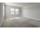 Empty bedroom with carpet flooring and ample natural light from two large windows at 16069 E Elk Dr, Denver, CO 80239