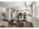 Open dining area with a modern table set, flowing seamlessly into a bright kitchen with sleek, black appliances at 16069 E Elk Dr, Denver, CO 80239