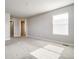 An empty room with carpet flooring, neutral color scheme, and a large window at 16069 E Elk Dr, Denver, CO 80239