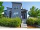 Contemporary home featuring a gray exterior, modern architecture, and a welcoming front entrance with landscaped steps at 16069 E Elk Dr, Denver, CO 80239
