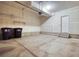 Bright garage with concrete floor, access door, and space for two cars and storage at 16069 E Elk Dr, Denver, CO 80239