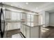 Spacious open-concept kitchen featuring granite countertops, white cabinets, and stainless steel appliances at 16069 E Elk Dr, Denver, CO 80239