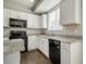 Bright kitchen features granite countertops, white cabinets, and stainless steel appliances at 16069 E Elk Dr, Denver, CO 80239