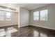 Bright, open living room with dark floors, flowing seamlessly into a kitchen, offering versatile living space at 16069 E Elk Dr, Denver, CO 80239