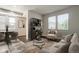 Bright living room featuring contemporary furnishings, modern shelving, and ample natural light from large windows at 16069 E Elk Dr, Denver, CO 80239