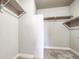 Bright, carpeted walk-in closet with white walls and shelves at 16069 E Elk Dr, Denver, CO 80239