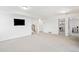 Finished basement featuring an open layout, a staircase, a mounted tv, and ample space for various activities at 31969 Robinson Hill Rd, Golden, CO 80403