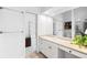 Well-lit bathroom featuring a vanity with storage, a large mirror, and a neutral color palette at 31969 Robinson Hill Rd, Golden, CO 80403
