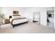 Spacious bedroom with neutral decor and a view into ensuite bathroom at 31969 Robinson Hill Rd, Golden, CO 80403