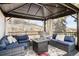 Covered outdoor deck area with fire pit and comfortable seating for relaxation at 31969 Robinson Hill Rd, Golden, CO 80403