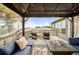 Relaxing covered deck with outdoor seating area and a cozy fire pit at 31969 Robinson Hill Rd, Golden, CO 80403