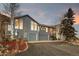 Exterior of gray home with well-kept landscaping in front and ample parking in driveway at 31969 Robinson Hill Rd, Golden, CO 80403