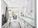Bright kitchen featuring white cabinets, modern appliances, and an adjacent dining area at 31969 Robinson Hill Rd, Golden, CO 80403