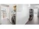 Laundry room with tile floors, front load washer and dryer, and adjacent hallway at 31969 Robinson Hill Rd, Golden, CO 80403