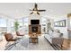 Bright and airy living room with vaulted ceilings, fireplace, and expansive mountain views at 31969 Robinson Hill Rd, Golden, CO 80403