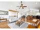 Open-concept living room and dining area with hardwood floors and natural light at 31969 Robinson Hill Rd, Golden, CO 80403