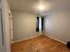Bedroom featuring hardwood floors, a window with curtains, and neutral paint at 723 Newton St, Denver, CO 80204