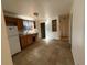 Kitchen with wood cabinets, tile flooring, standard appliances, and an adjacent area with shelves at 723 Newton St, Denver, CO 80204