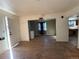 Spacious living room with hardwood floors, a washer, and an open layout leading to the kitchen at 723 Newton St, Denver, CO 80204