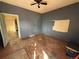 An empty living room shows damaged walls, floors, and a need for immediate renovation at 723 Newton St, Denver, CO 80204