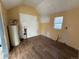 A room with exposed plumbing and electric awaits renovation with vinyl flooring and natural light at 723 Newton St, Denver, CO 80204