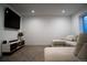 Finished basement with TV, sectional, and carpet flooring; a cozy space for entertainment and relaxation at 4172 Deer Watch Dr, Castle Rock, CO 80104