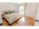 Cozy bedroom featuring modern decor, warm sunlight, and hardwood floors at 4172 Deer Watch Dr, Castle Rock, CO 80104
