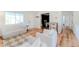 Open living room with modern furniture, including a plush white sofa and chairs, providing a comfortable and stylish area at 4172 Deer Watch Dr, Castle Rock, CO 80104
