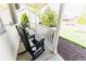 Relaxing front porch featuring classic rocking chairs and a peaceful neighborhood view at 4172 Deer Watch Dr, Castle Rock, CO 80104