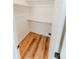 Bright, airy walk-in closet featuring wood-look flooring and ample shelving for optimal storage solutions at 4172 Deer Watch Dr, Castle Rock, CO 80104