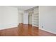 View of bedroom showcasing wood floors and closet with built-in shelving at 3512 S Kittredge St # A, Aurora, CO 80013