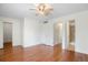 Bedroom featuring wood floors, ceiling fan and ensuite bathroom at 3512 S Kittredge St # A, Aurora, CO 80013
