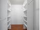 Walk-in closet showcasing built-in shelving and wood floors at 3512 S Kittredge St # A, Aurora, CO 80013