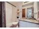 Well-lit bathroom featuring a vanity with granite countertop and tub with shower at 8426 W 97Th Pl, Broomfield, CO 80021