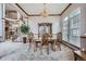 Elegant dining room with wood table and chairs, chandelier, and stairway, creating a space for gatherings at 8426 W 97Th Pl, Broomfield, CO 80021
