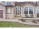 Close-up of the home's entrance, showcasing the covered porch with seating at 8426 W 97Th Pl, Broomfield, CO 80021