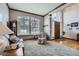Inviting living room features a large window and hardwood floors, creating a light-filled and welcoming space at 8426 W 97Th Pl, Broomfield, CO 80021