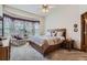 Cozy main bedroom featuring a large window, ceiling fan, and comfortable furniture at 8426 W 97Th Pl, Broomfield, CO 80021