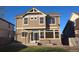 The backyard features tan siding, a concrete patio, and a grassy area for outdoor enjoyment at 4995 S Algonquian Way, Aurora, CO 80016