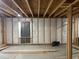 Unfinished basement featuring exposed ceiling, window with curtain, and room for customization at 4995 S Algonquian Way, Aurora, CO 80016
