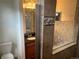 Bathroom featuring granite vanity with decorative tile accents and a glass shower partition at 4995 S Algonquian Way, Aurora, CO 80016