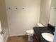 Bright bathroom features a toilet, vanity with dark countertop and tiled walls at 4995 S Algonquian Way, Aurora, CO 80016