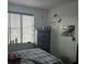 Cozy bedroom featuring a plaid comforter, window, and wall decorations at 4995 S Algonquian Way, Aurora, CO 80016