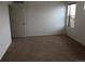 Simple bedroom with neutral carpet, a white door, and a window with blinds at 4995 S Algonquian Way, Aurora, CO 80016